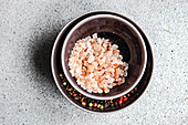 Himalayan salt and coloured pepper in bowls