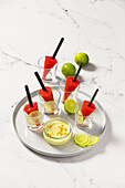 Strawberry margarita pops with passion fruit sauce