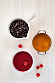 Sweet toppings for waffles - blueberry sauce, caramel and raspberry sauce