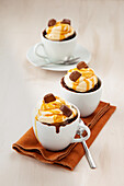 Chocolate microwave mug cakes with cream and chocolate candies
