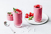 Raspberry smoothie with oat milk, soy yogurt, lemon and mint