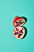 Halved pomegranate on a turquoise background