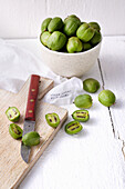 Kiwi berries in a bowl and on a wooden board