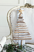 Christmas decoration object made of driftwood on an antique chair