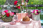 Garden table with spring flowers and cake