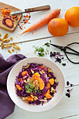 Red cabbage salad with oranges, apple, carrots and nuts