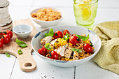 Roasted chicken on couscous with peppers and tomatoes