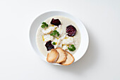 Jerusalem artichoke cream with cod and beets