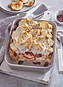 Baked meringue bread pudding with apples and cranberries