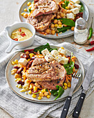 Corn and chickpea salad with feta and pork neck
