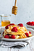Coconut pancakes with fresh raspberries and maple syrup