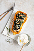 Butternut squash half stuffed with spinach and feta cheese