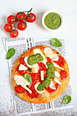 Tomato pizza with salted ricotta and pesto
