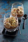 Layered caramel desserts with bananas, pistachios and chia