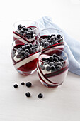 Layered desserts with blueberry jelly and frozen blueberries