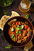 Lamb balti curry with naan bread and beer