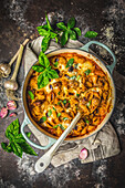 Baked pasta and cheese with sausages in a casserole dish