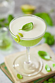 Gin cocktail with basil, lime, and egg white foam