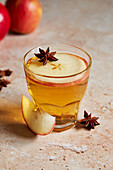 White mulled wine with apple slice and star anise