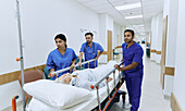 Wheeling patient bed through hospital corridor