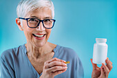 Senior woman taking dietary supplement