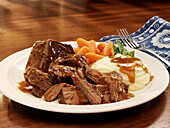 Braised beef with gravy, mashed potatoes and carrots