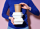 Person holding take-out containers