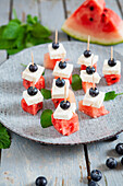 Bites with watermelon, feta, blueberries, and mint
