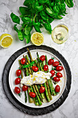 Fried green asparagus with burratini, cherry tomatoes and lemon zest