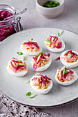 Boiled eggs with smoked salmon, pickled red onions, and green spring onions