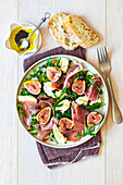 Rocket salad with Parma ham, figs, and mozzarella cheese