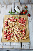 Puff pastry sticks with pistachios, basil, and strawberries