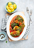 Savoy cabbage roulades in a delicious tomato sauce with potatoes