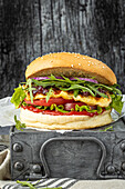 Vegetarian burger with halloumi, cranberry jam, rocket salad, and red onions