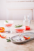 Vodka Sour with blood orange juice, and rosemary garnish