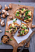 Baked bread topped with mushrooms, almond cheese and tofu