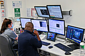 Radiologists monitoring patient undergoing radiotherapy