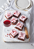 Brownies with pink frosting and red wine