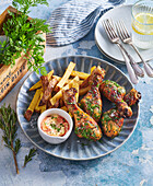 Roasted chicken legs with herbs fries