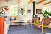 Living room with leather armchairs, sofa and blue carpet