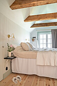 Brightly decorated bedroom with exposed wooden beams