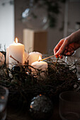 Hand lights candles for Christmas table decoration