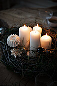 Advent arrangement with candles and Christmas decorations on a wooden table