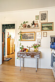 Vintage-style console table with decorations and picture gallery on the wall