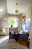 Children's room with bed, wall shelf, wooden floor and carpet