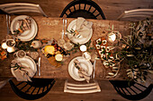 Festively laid table with candles and olive branches