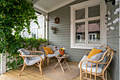 Cosy veranda with rattan furniture and yellow accent cushions