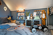 Children's room with bookshelf, wall decoration and retro slide car