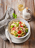 Chicken pasta salad with cherry tomatoes and basil