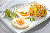 Vegetable rice tempura with fried eggs and lime